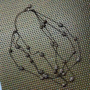 4 strands of circular and oval gold beads.